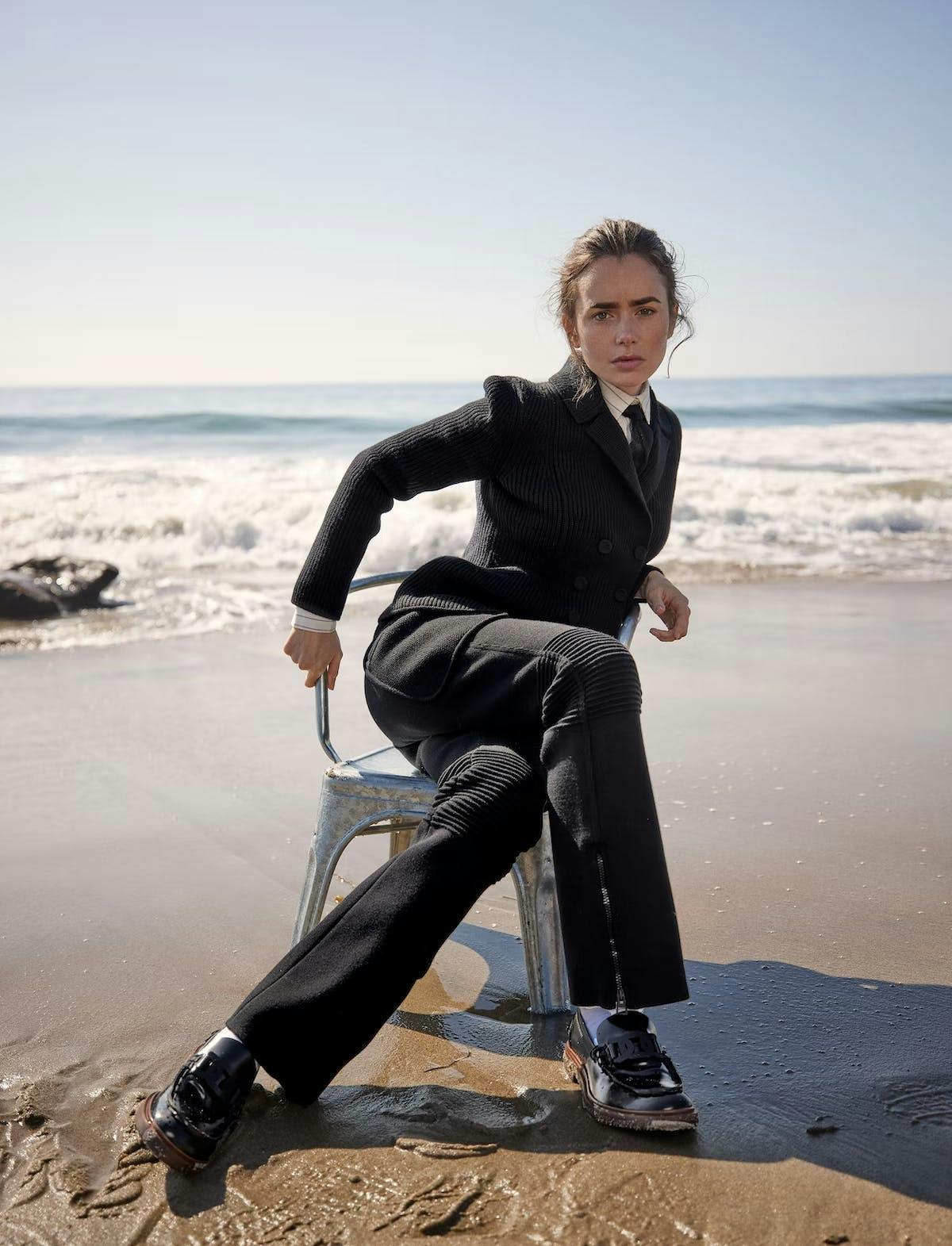 sitting person suit formal wear blazer jacket shoe footwear pants beachwear