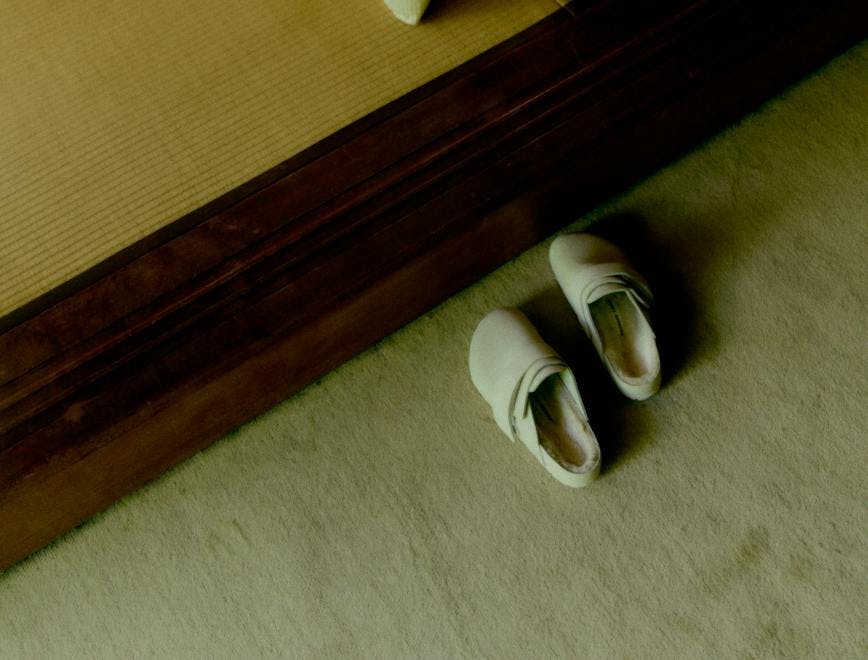wood hardwood floor flooring indoors interior design shoe sandal linen person