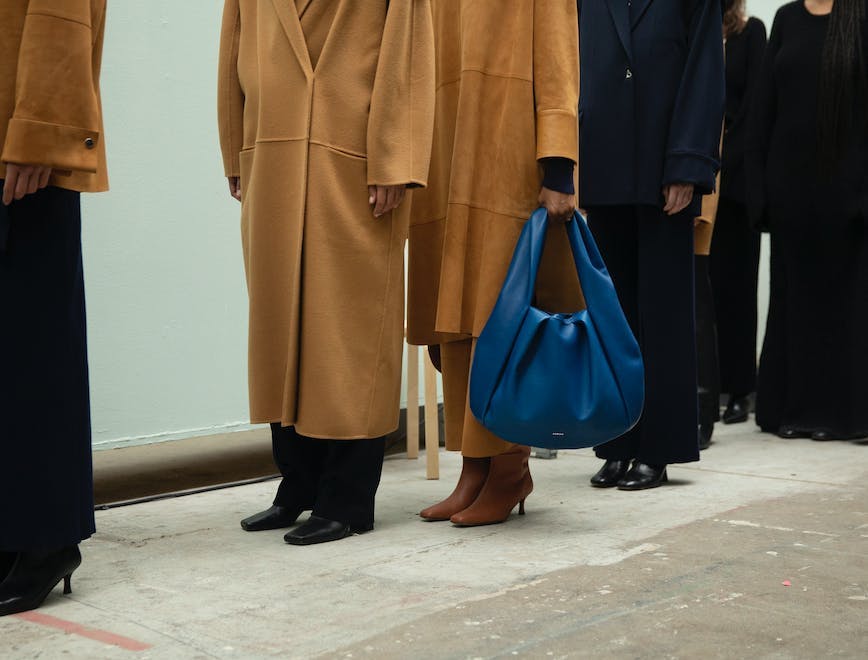 coat bag handbag adult female person woman overcoat high heel purse