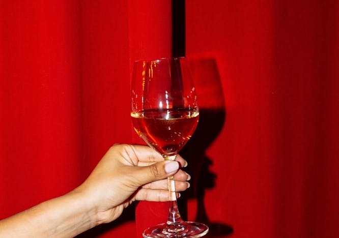 glass goblet body part finger hand person alcohol beverage liquor wine