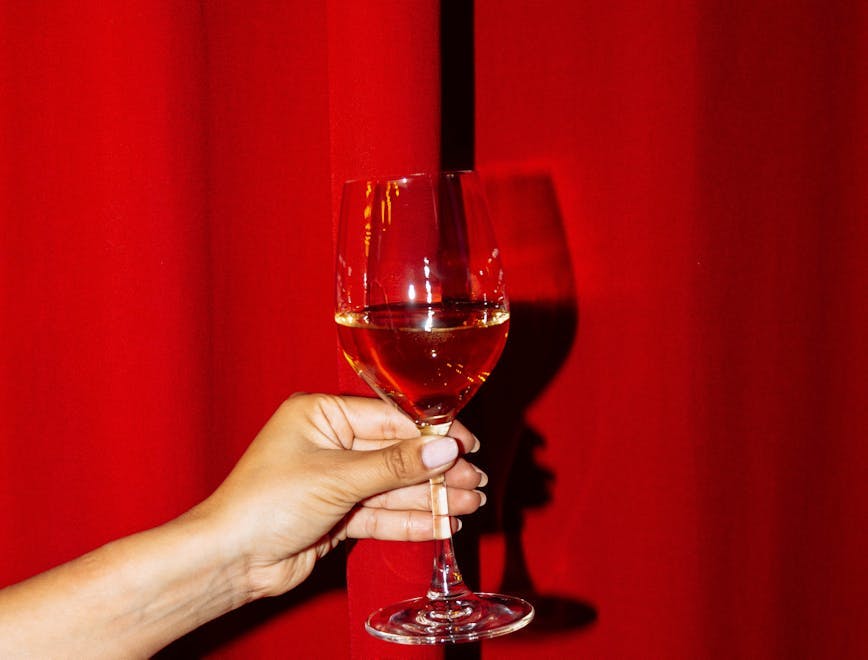 glass goblet body part finger hand person alcohol beverage liquor wine